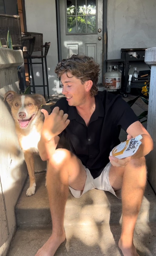 Dakota Sheets, founder of DogSauce, holding a DogSauce pouch